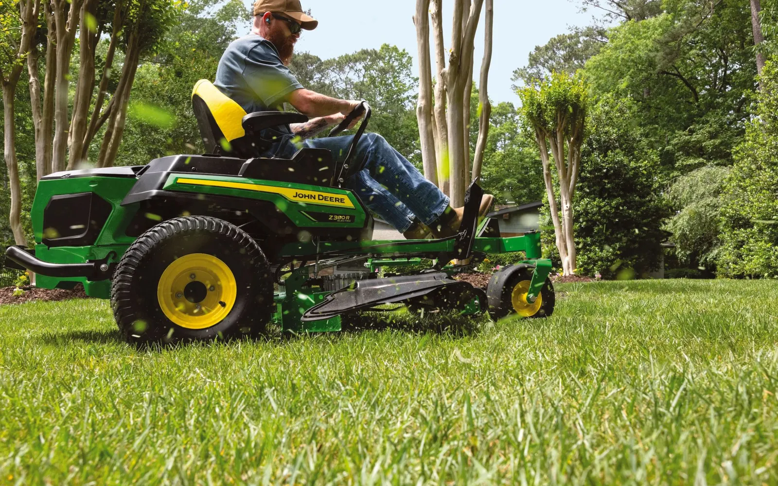 Lawn mowing on a large green lawn with a zero-turn mower